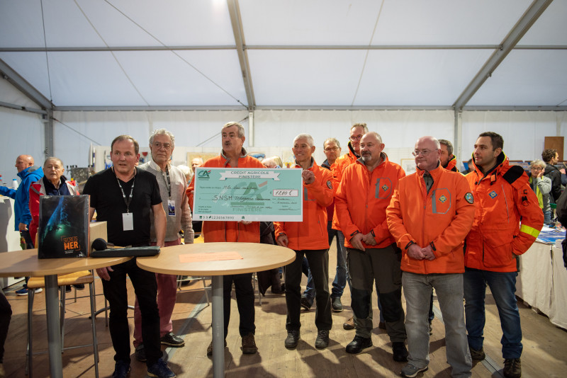 © photo SNSM de Trévignon-Concarneau : Eric Berthou, président de l'association Secrets de mer éditions remet un chèque de 1200 Euros à la station SNSM  de Trévignon-Concarneau, partenaire du festival  Livres et mer de Concarneau..